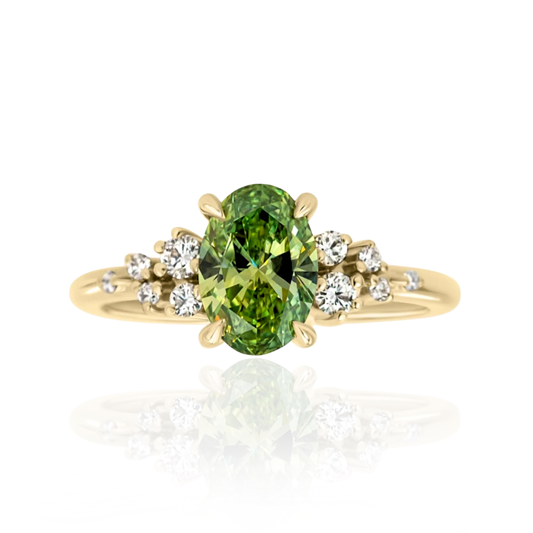 Gold ring with a green gemstone and smaller diamonds on a white background