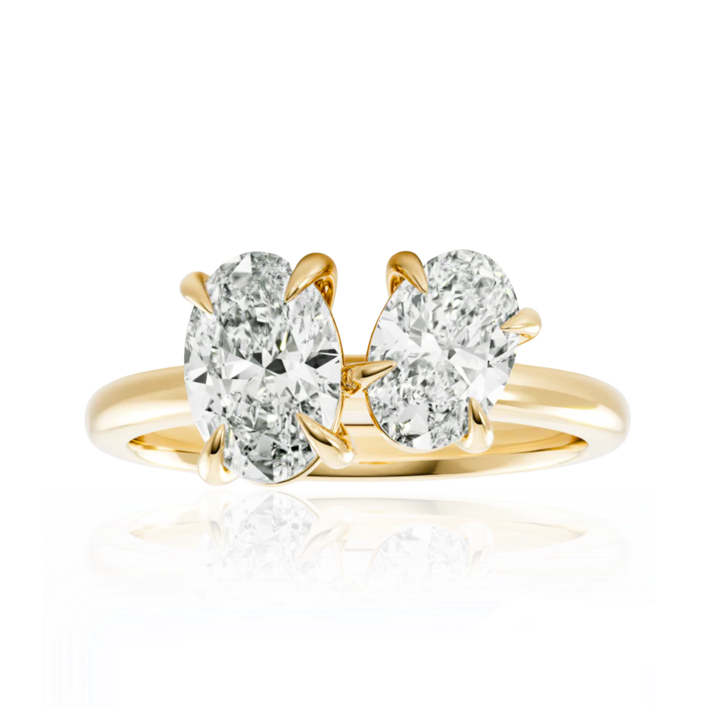 Gold ring with two pear-shaped diamonds on a white background