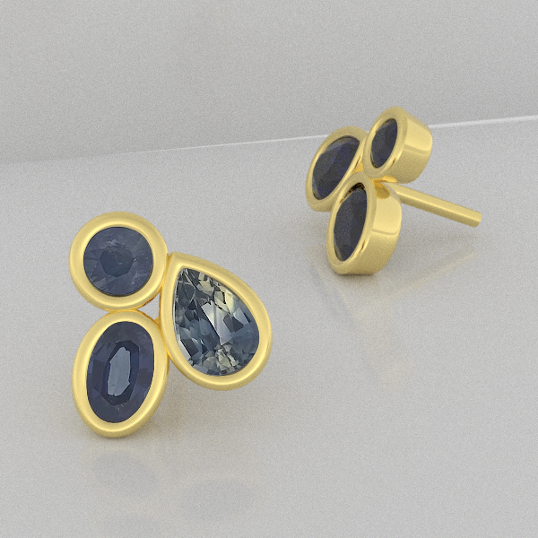 Gold earrings with blue australian sapphires gemstones on a light gray background stud earrings sydney